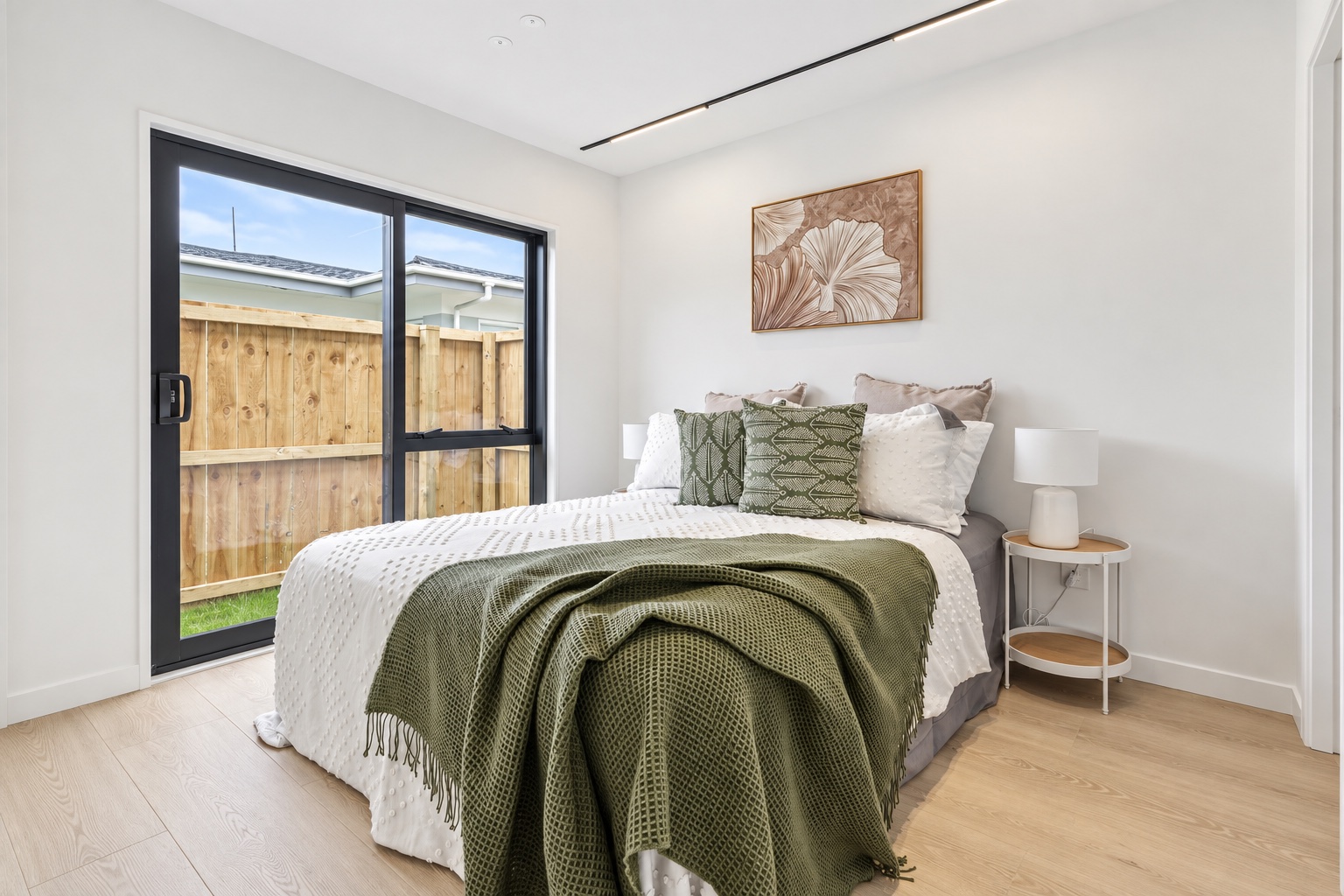 Bedroom styled with natural timber and layered linens